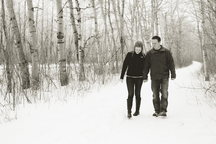 winter walk engagement photos among birch trees