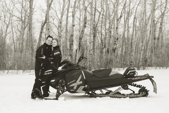 photo of adventurous couple and their skidoo during their engagement session