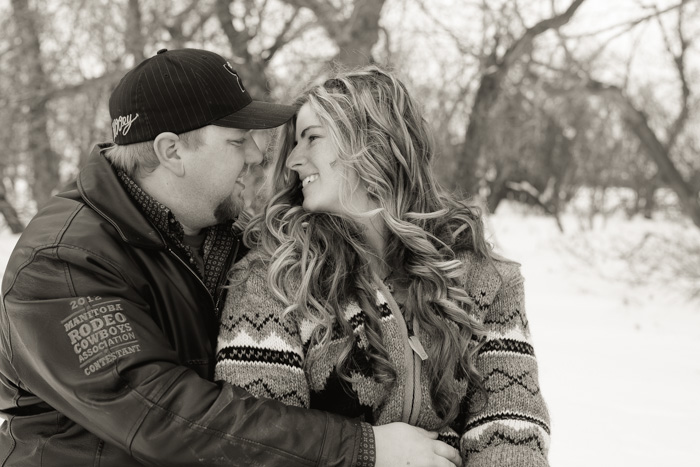 winter engagement photo with couple cuddling