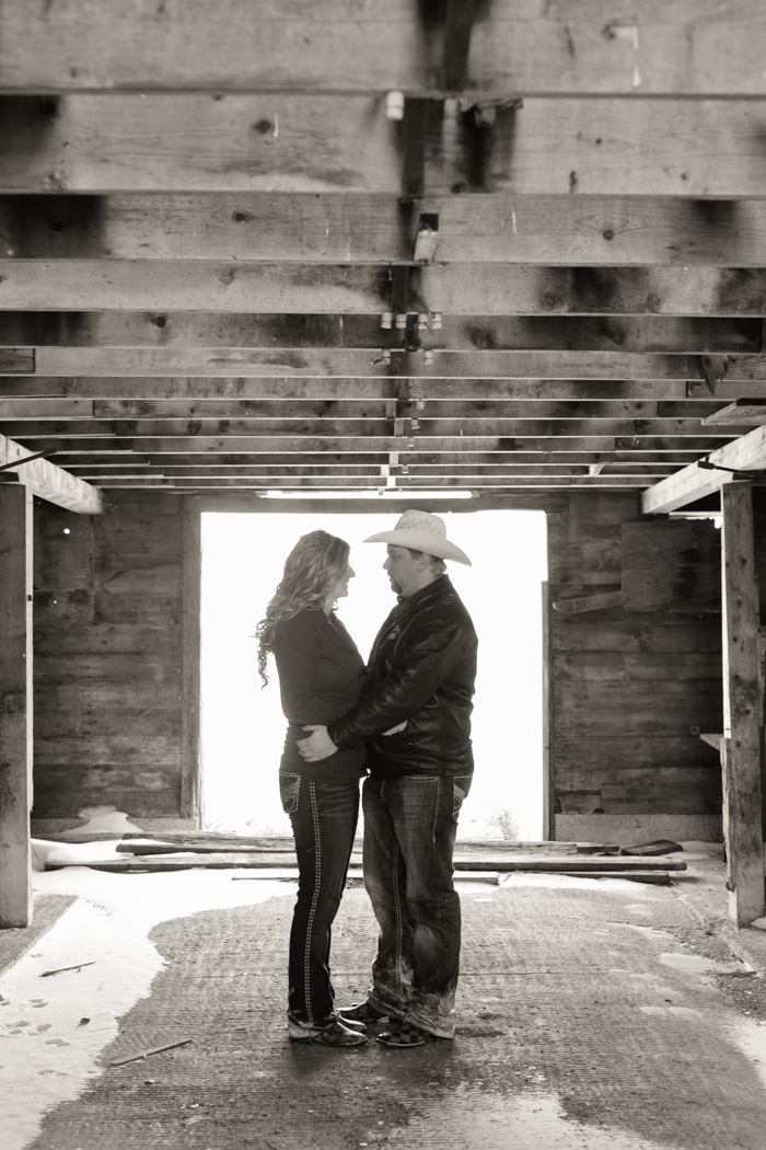 romantic engagement photo in rustic barn black and white