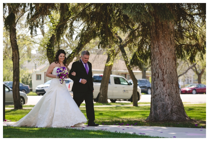 photo of beautiful spring bride walking down the aisle with her father