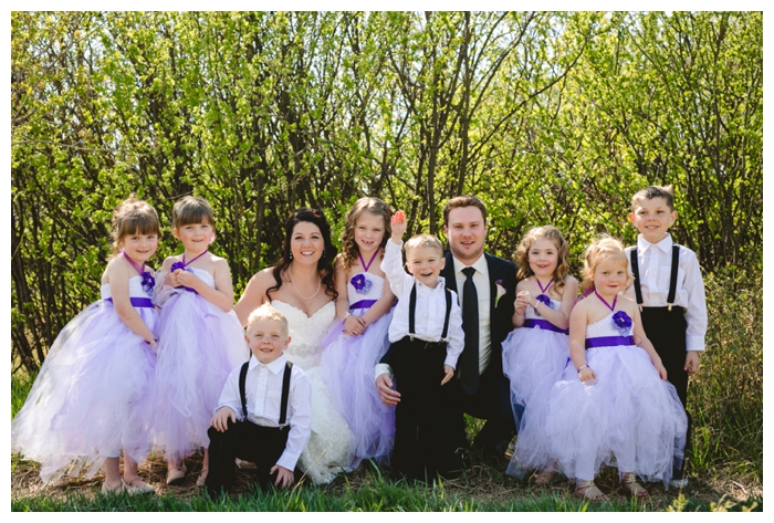 photo of bride and groom with five flower girls and three ring bearers