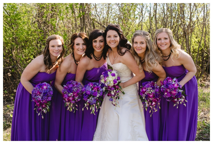 photo of beautiful bride with bridesmaids with purple strapless dresses