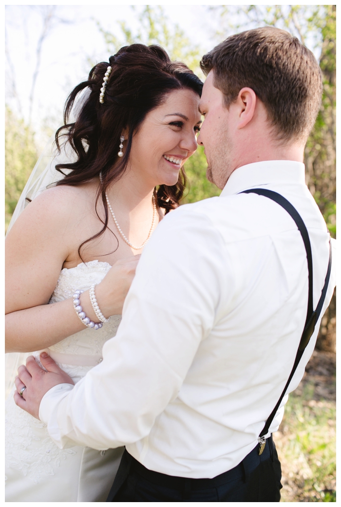 photo of bride pulling on husbands suspenders