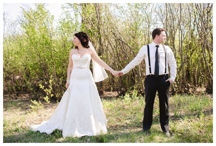 photo of bride and groom looking away from each other in the woods