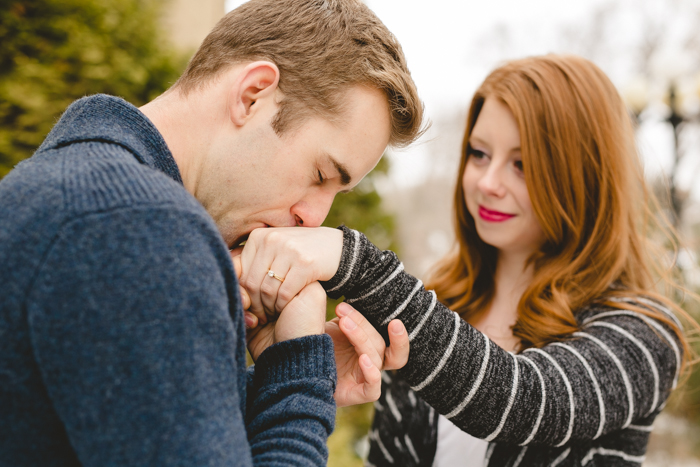photo of man kissing woman's ring hand