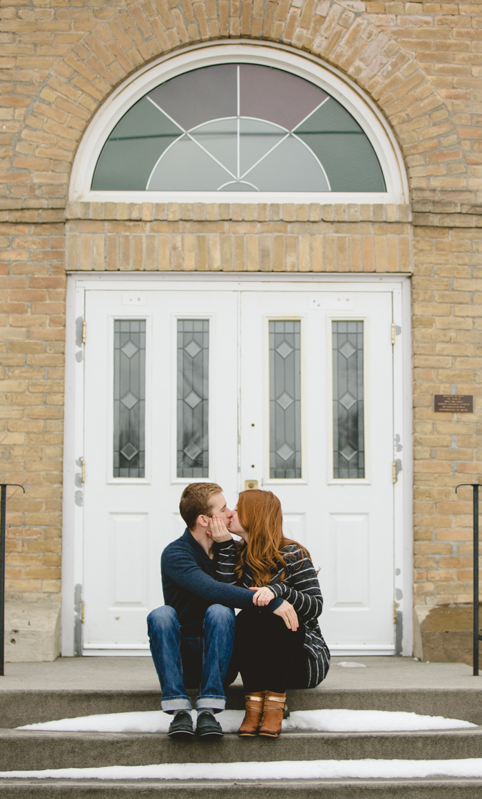 photo of engaged couple on the steps of a church in wolseley saskatchwan