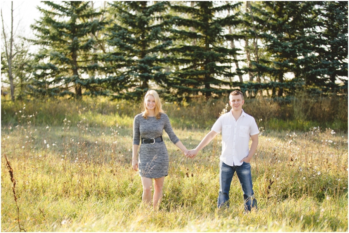 photo of couple standing in a field on a fall day