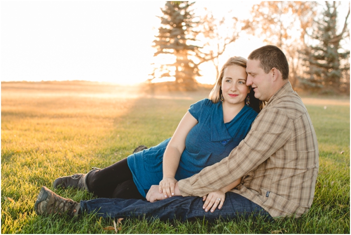 photo of couple sitting in the grass