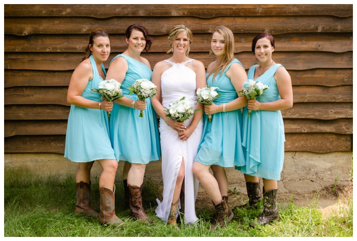 photo of bride with bridesmaids wearing turquoise dresses and cowboy boots