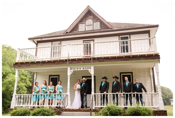 photo of bridal party stinging on balcony of vintage home