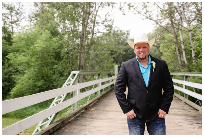 photo of groom wearing turquoise shirt and white straw cowboy hat