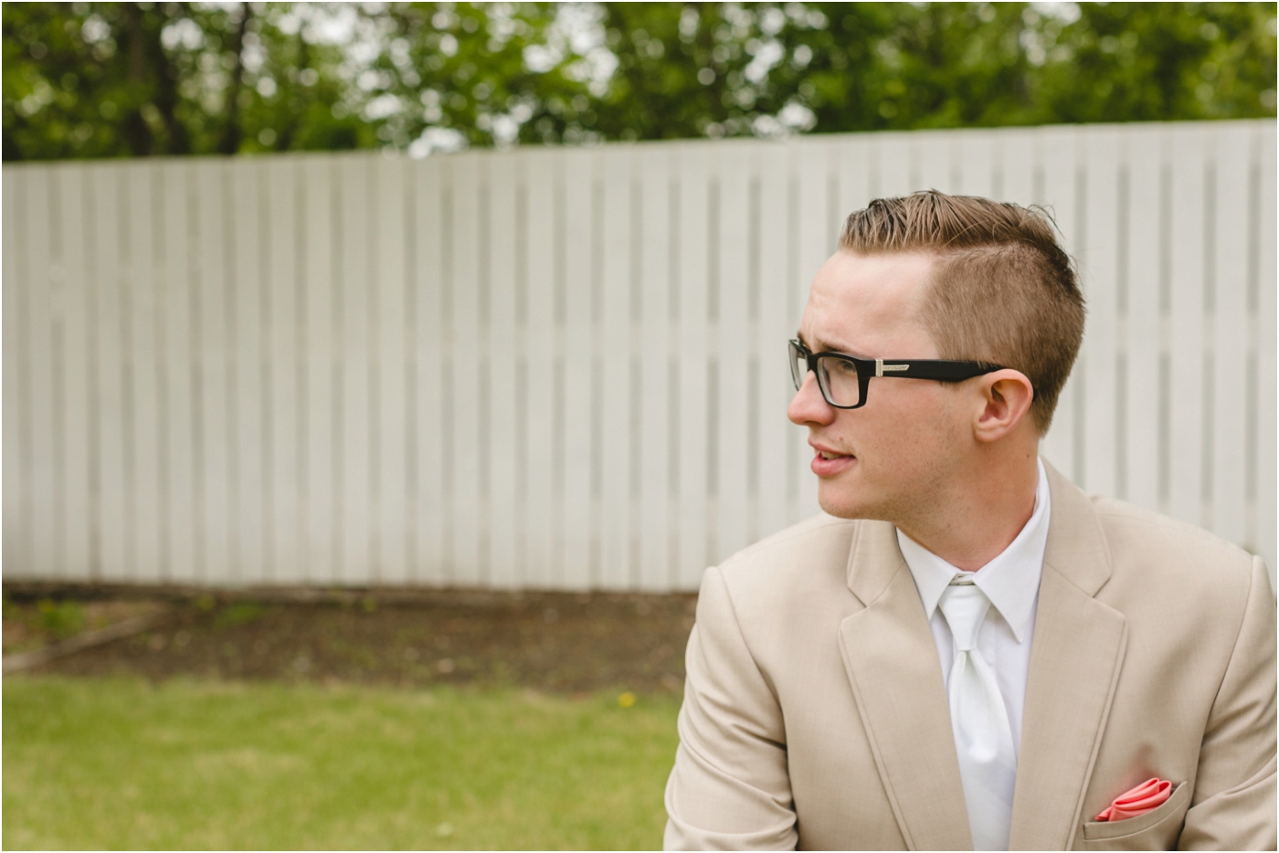 hipster groom wearing tan suit and white tie