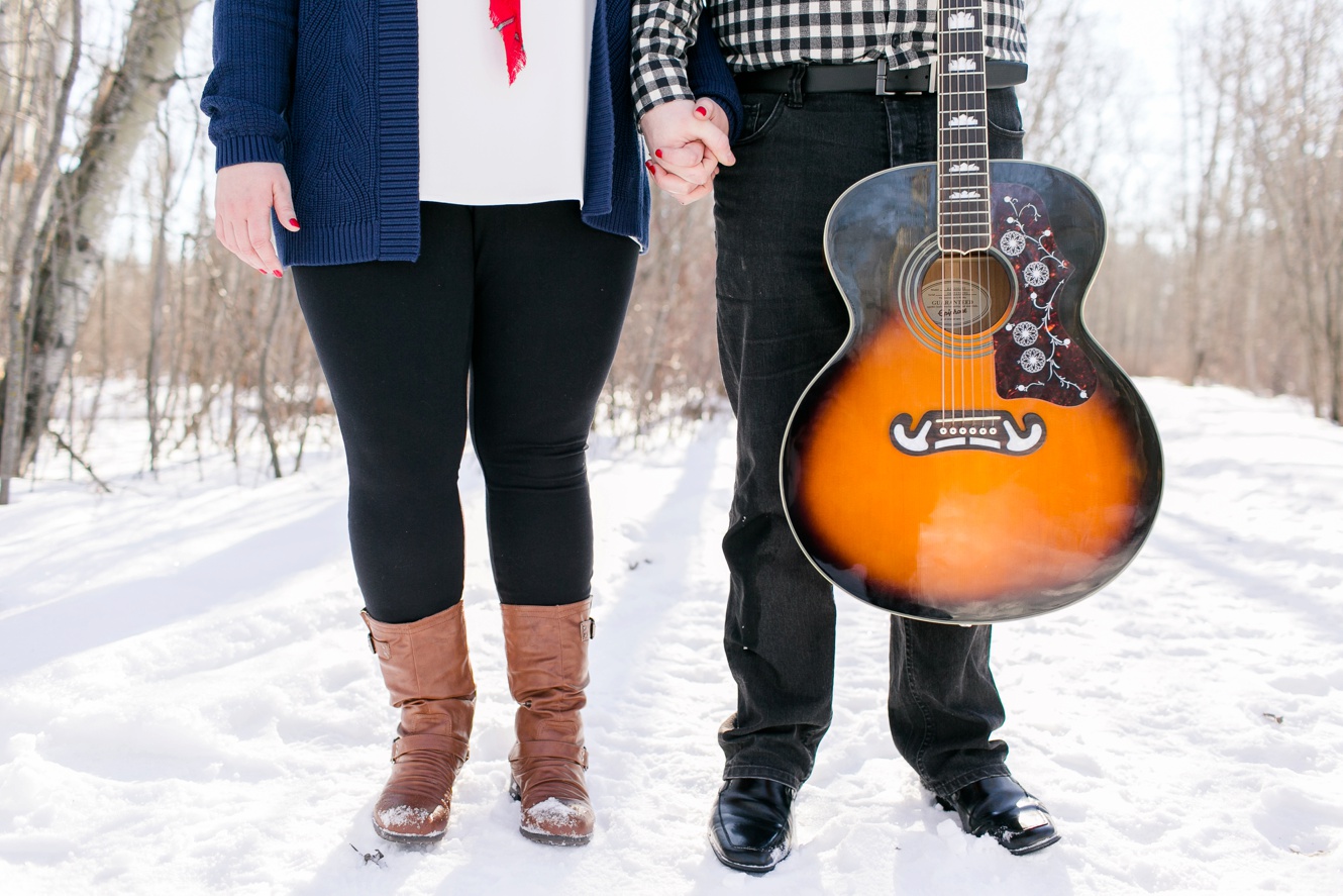 engagement session picture of a couple holding guitar
