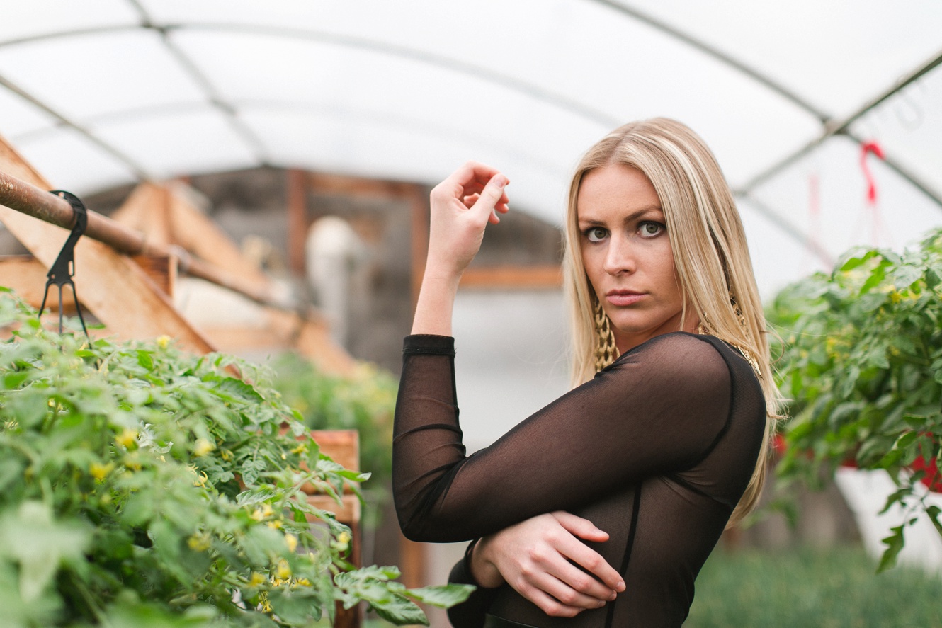 model in sheer nude black shirt in greenhouse fashion shoot photo