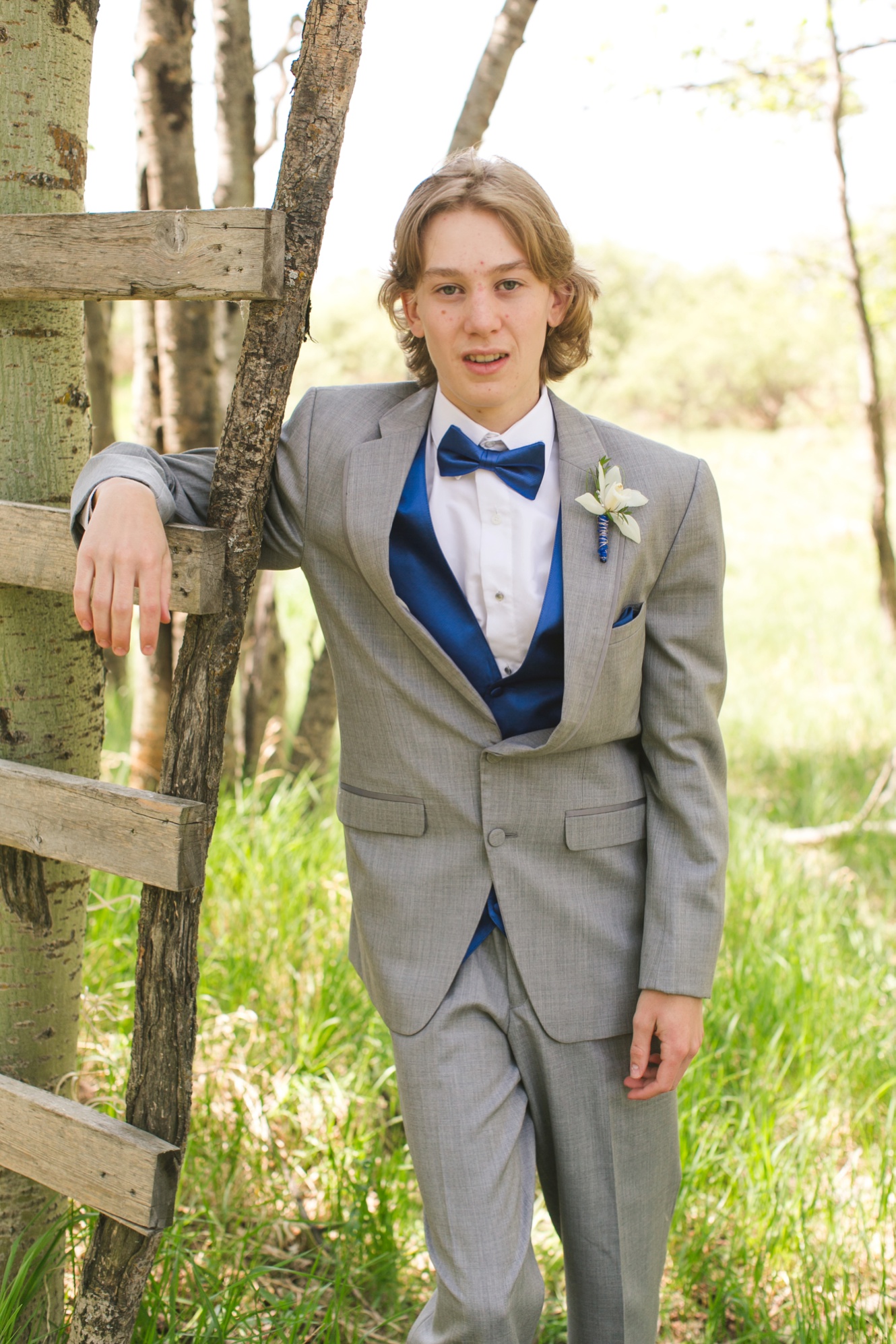 Photo of grad in a tux with blue bow tie photo