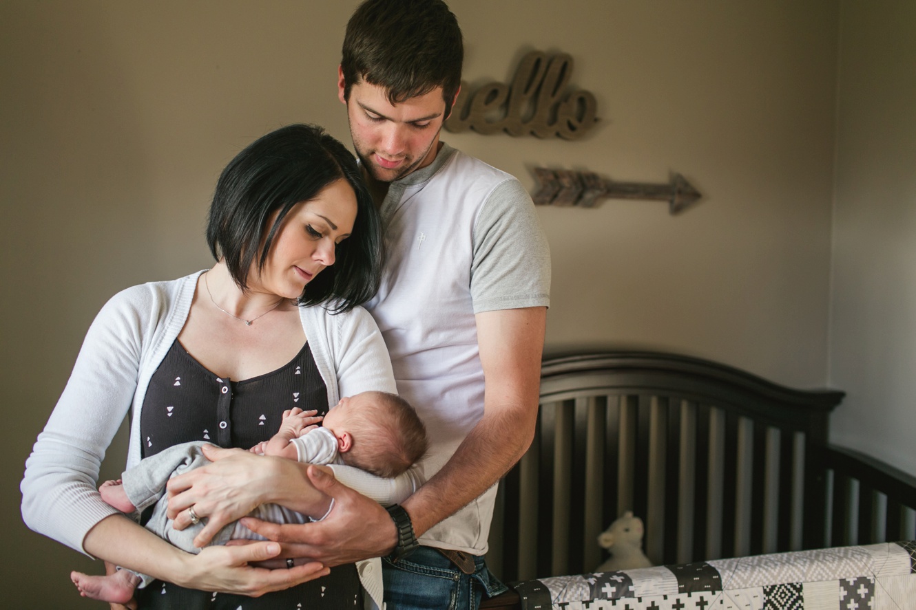 Photo of new parents with their baby boy photo