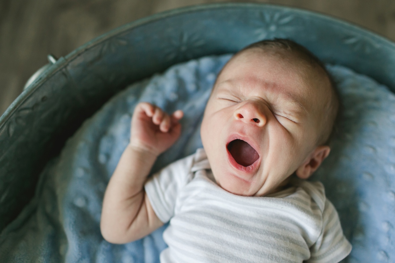 Adorable baby boy yawning photo