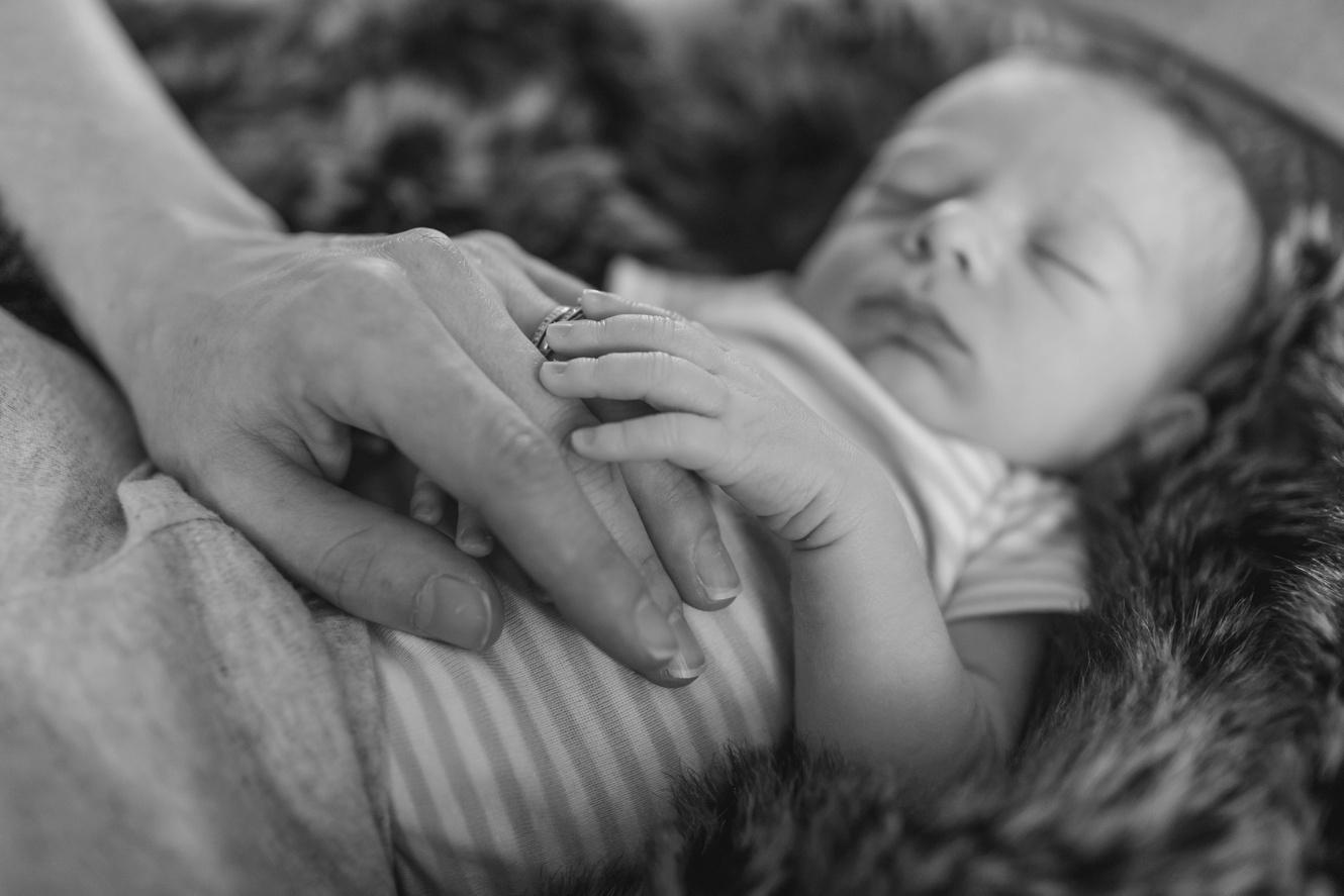 newborn baby boy and mom's hand