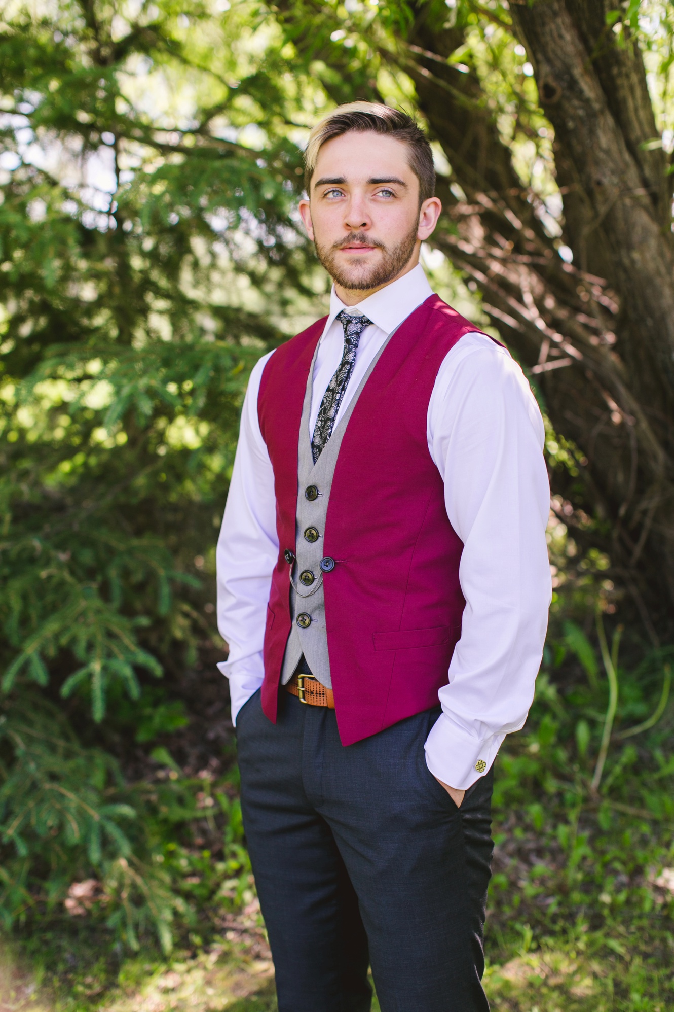 high school graduate dressed in burgundy vest and patterned tie