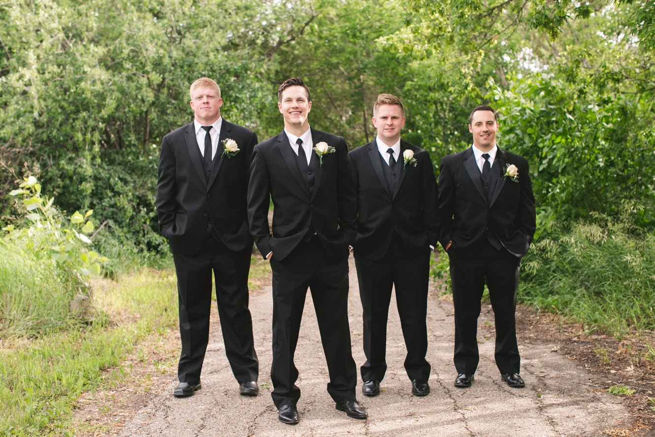 groomsmen in black coats ties and shoes photo
