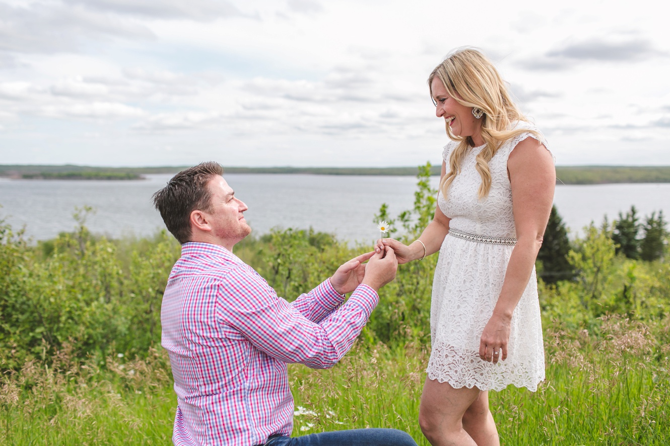 Engagement at Kenosee Lake lookout point on one knee photo