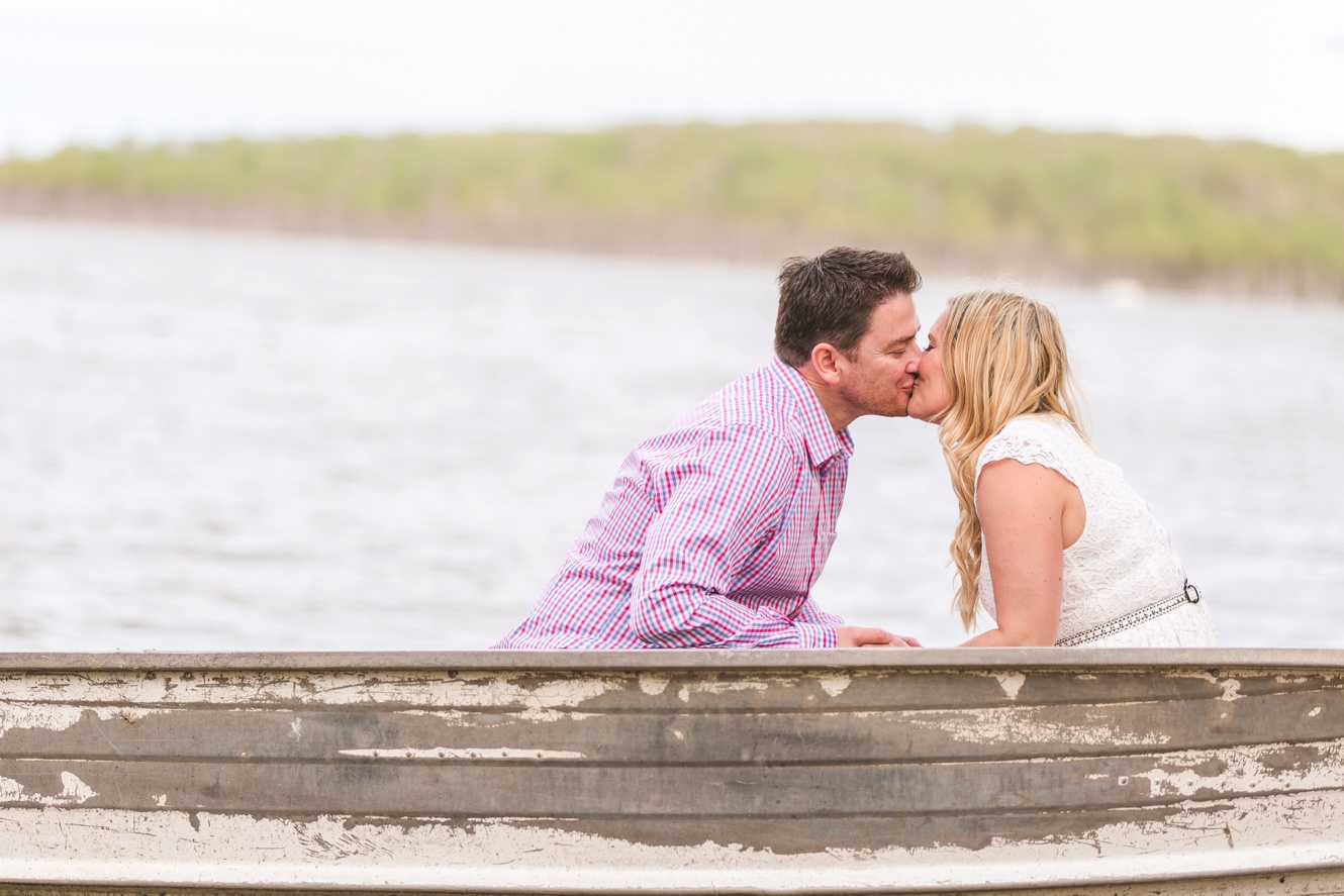 Romantic summer engagement canoe kissing photo