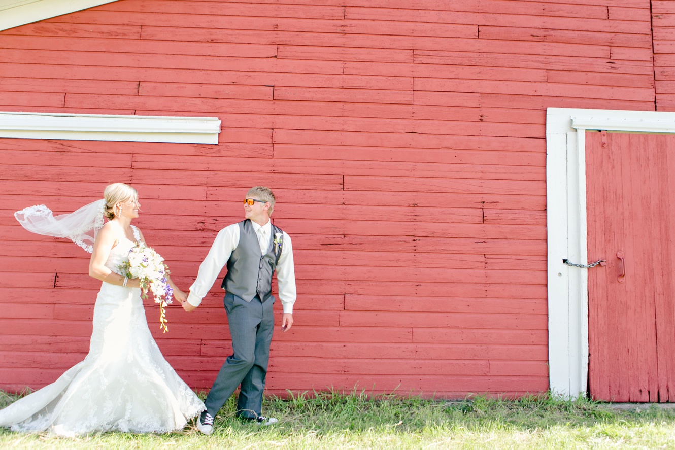 married couple by a red barn