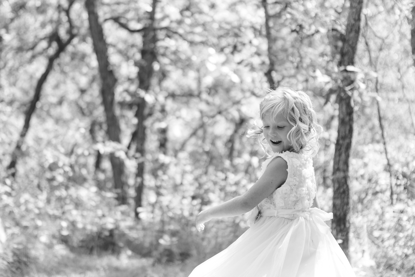 photo of flower girl playing in the woods