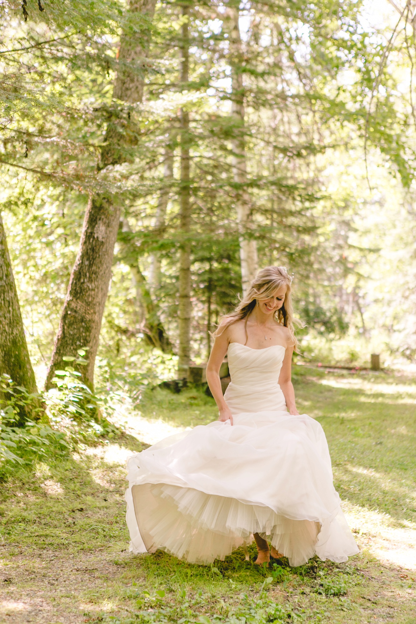 bride frolicking in the woods barefoot photo