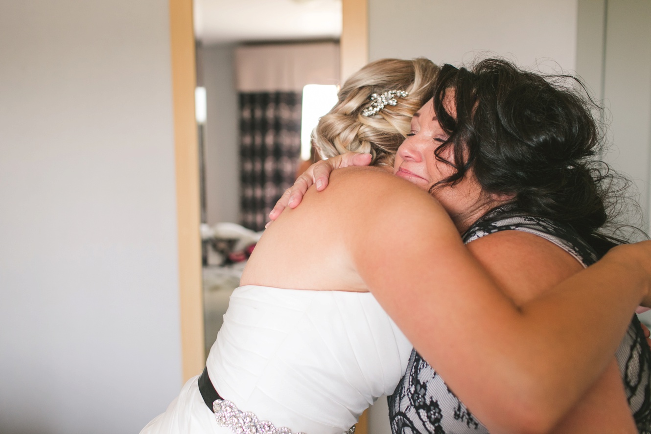 Bride hugging Mom photo
