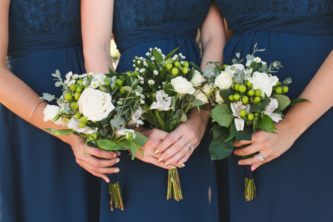 navy bridesmaid dresses and white floral bouquets photo