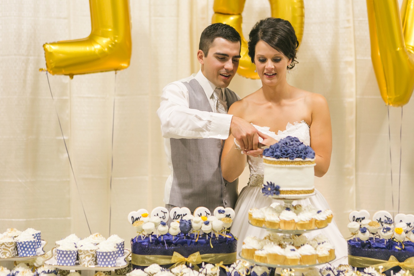 Classic Navy and Gold cake cutting Saskatchewan Wedding Pictures