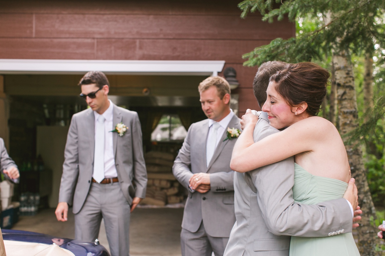 sister hugging the groom photo