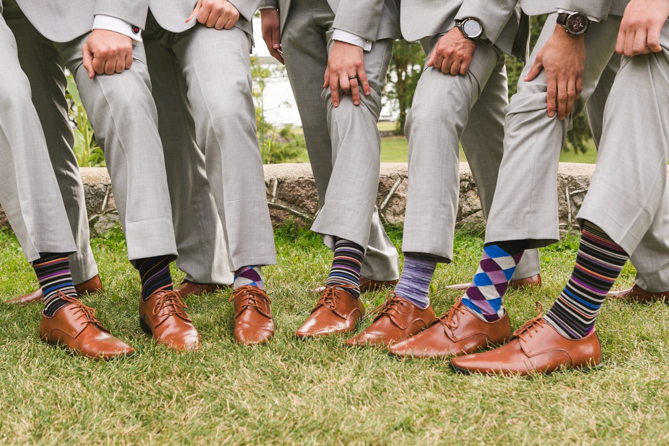 Groomsmen showing off their patterned socks photo