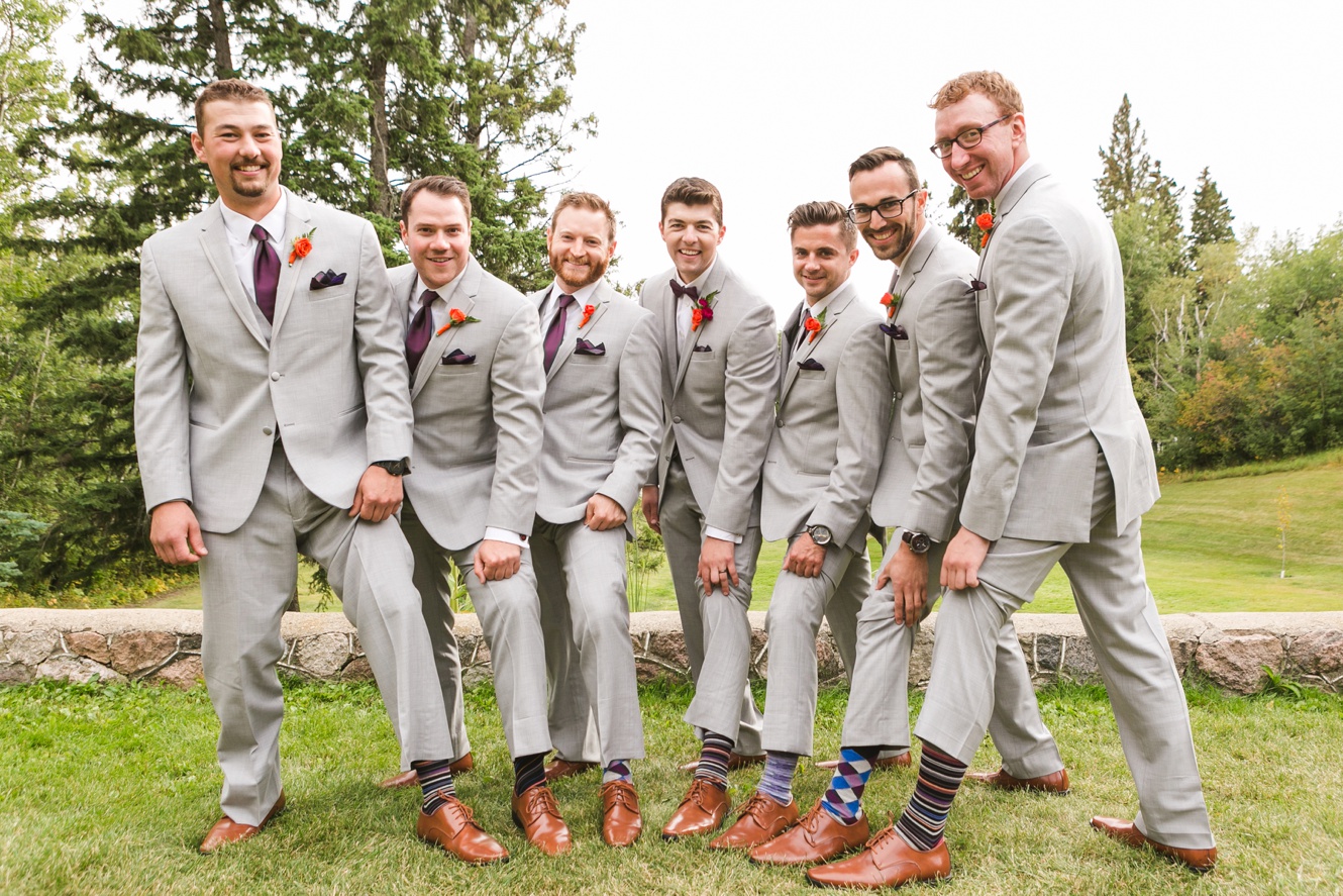 groomsmen showing off patterned socks photo