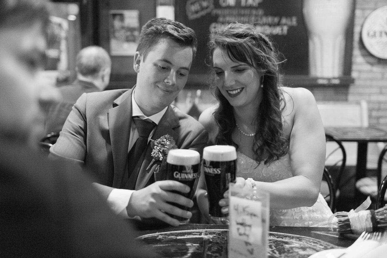 Bride and groom drink guinness