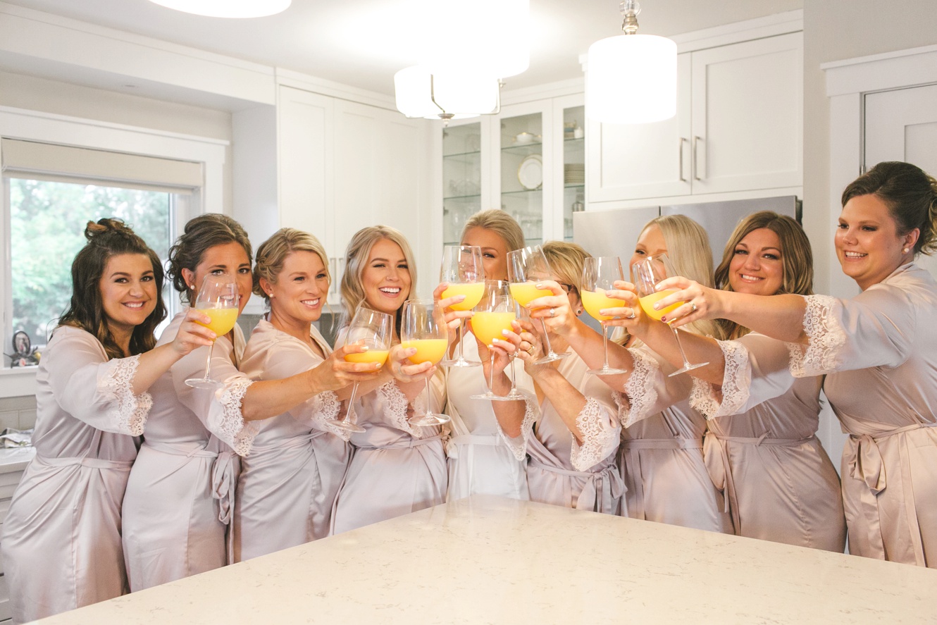Bridesmaids cheers with mimosas photos