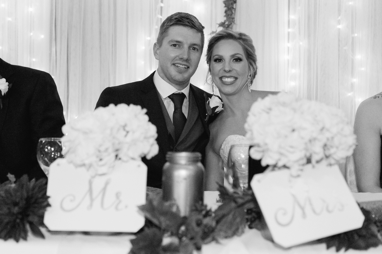 Black and white photo of bride and groom at reception photo