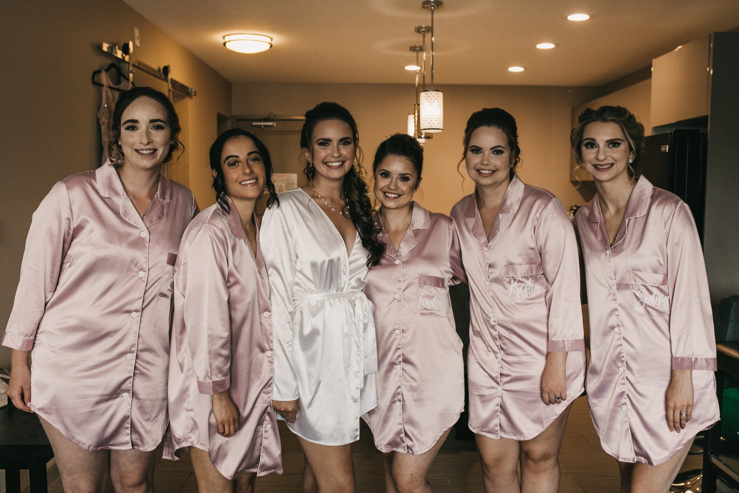 Bridesmaids getting ready in pink robes photo
