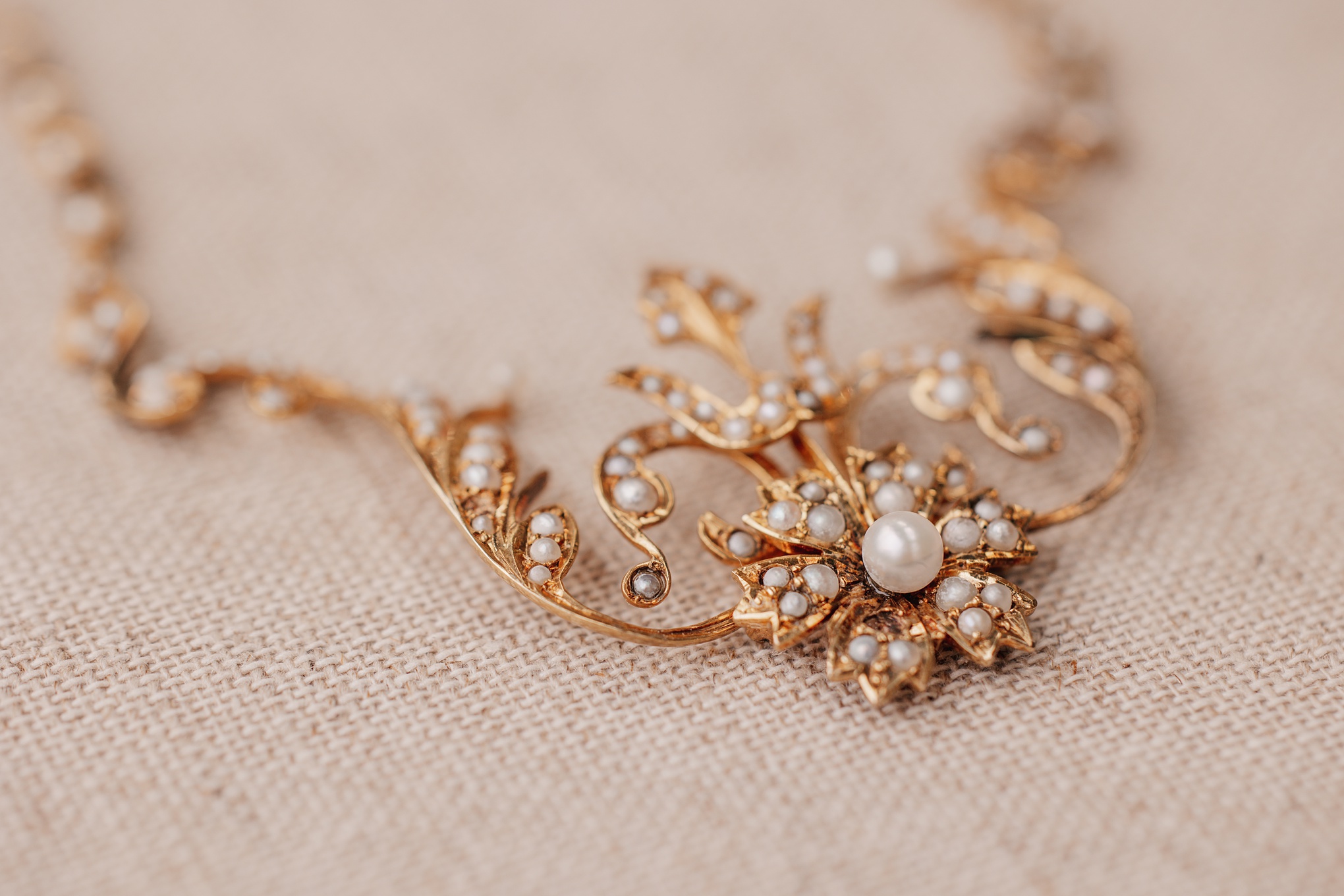 Vintage pearl and gold necklace worn by bride at wedding