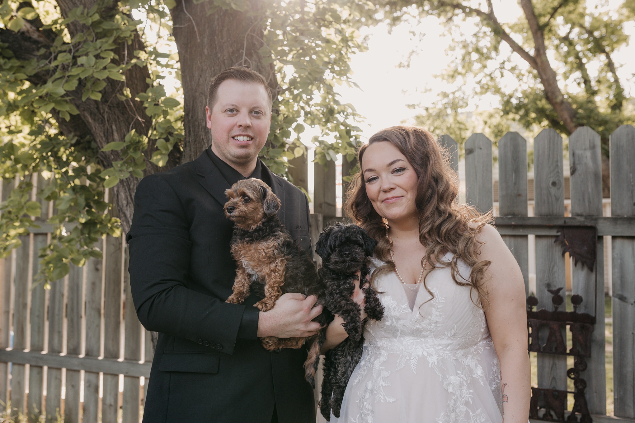 Bride and groom with their dogs on their wedding day